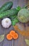 Vegetables on wooden background scattering of spices and a Bay leaf parsley sprig