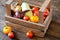 Vegetables in wooden crate. Tomatoes, onions, squash