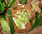 Vegetables on a wooden kitchen board, green onions, dill and peas, sliced cabbage on a wood background, concept of fresh and