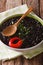 Vegetarian black bean soup close up in a bowl. Vertical