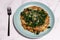 Vegetarian black beans risotto with charred kale and vegan cheese topping