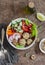 Vegetarian buddha bowl - quinoa meatballs and vegetable salad on wooden background, top view. Healthy, vegetarian food