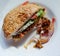 Vegetarian burger with seitan, tomato, lettuce, white bun with mayonnaise. Homemade veggie burger with seitan and sesame seeds