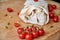 Vegetarian burrito with vegetables decorated with chopped cherry tomatoes close up. On blurred foreground small cherry tomatoes