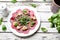 Vegetarian carpaccio of roasted beetroot with cauliflower and green salad