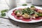 Vegetarian carpaccio of roasted beetroot with cauliflower and green salad