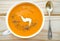 Vegetarian carrot-pumpkin cream soup with garlic and cumin