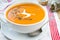 Vegetarian carrot-pumpkin cream soup with garlic and cumin