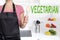 Vegetarian chef holding wooden spoon background