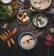 Vegetarian chestnuts creamy soup bowl on dark rustic kitchen table background with cooking pot ,ingredients and autumn leaves , to