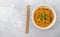 Vegetarian chili noodles. Light background, copy space.