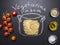 Vegetarian cooking pasta, painted pot, cherry tomatoes, Oil and seasonings wooden rustic background top view