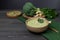 Vegetarian cream soup made of broccoli, potatoes, onions, garlic, sesame and olive oil, and coconut milk served in a wooden bowl.