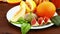 Vegetarian diet. On the table lie fruit: Vietnamese melon, figs, kiwi, oranges, juice. Close-up.