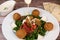 Vegetarian dish, falafel balls from spiced chickpeas with chopped parsley, fresh onions and tomato, tahini sauce