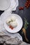 Vegetarian dish, mashed potatoes with tomatoes and rosemary on black background. Studio shot, top view.