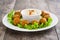 Vegetarian falafels, lettuce and hummus on a rustic wooden table