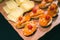Vegetarian Finger Food with toast, orange hummus, cherry tomatoes and chopped onions