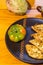 Vegetarian food - celery tuber slices fried in batter in a ceramic plate on a wooden table, close up