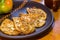 Vegetarian food - celery tuber slices fried in batter in a ceramic plate on a wooden table, close up