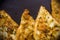 Vegetarian food - celery tuber slices fried in batter in a ceramic plate on a wooden table, close up