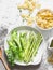 Vegetarian food ingredients for a healthy delicious lunch - pasta orecchiette, fresh green vegetables asparagus, peas, herbs on a