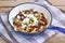 Vegetarian food with red beans,corn, mushroom, goat cheese, basil and onion on pan on wooden background