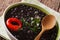 Vegetarian food: spicy black beans close up in a bowl. horizontal