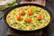 Vegetarian frittata with green onions and slices tomato