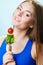 Vegetarian girl holding stack of vegetables.