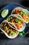 Vegetarian and healthy tacos made of tomatoes, avocado and hebrs