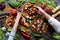 Vegetarian homemade party food concept. Woman and child hands reaching for pizza with champignons, bell peppers, eggplants and