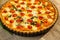 Vegetarian homemade pie, Quiche with tomatoes, spinach and feta cheese.