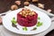 Vegetarian Lenten dish: a salad of beets with walnuts and garlic in a white plate