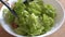 Vegetarian lettuce, onion and tomato salad is mixed in a white bowl