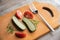 Vegetarian lunch, cucumbers and tomatoes and fork on a wooden background