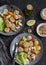 Vegetarian lunch - quinoa meatballs and vegetable salad on a dark table