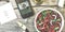 Vegetarian lunch. Salad of fresh vegetables, greens and red sweet peppers with olive oil. On the smartphone screen, a lunch displa