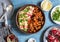 Vegetarian lunch table - eggplant and chickpea stew, bulgur, pomegranate and avocado. Top view