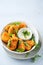 Vegetarian Nuggets with Vegan Dipping Sauce and rocket leaves on a light background with copy space, selective focus. Healthy Diet