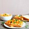 Vegetarian open sandwiches on a plate. Stewed white beans with vegetables and parsley on white bread slices. Healthiest food