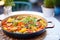 vegetarian paella with bell peppers and artichokes