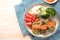 Vegetarian patties of broccoli and flaked oats with tomato, rice, vegetables and spicy sauce, blue napkin and light wooden table,