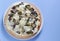 Vegetarian pizza with broccolli and mushrooms on the table blue background. Copy space. Top view