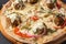 Vegetarian pizza with falafel and wholemeal dough on a black table close-up