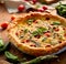 Vegetarian quiche with cherry tomatoes and green asparagus