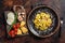 Vegetarian ravioli Pasta with Mozzarella, parmesan cheese and Tomato. Dark background. Top view