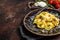 Vegetarian ravioli Pasta with Mozzarella, parmesan cheese and Tomato. Dark background. Top view. Copy space