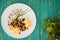 Vegetarian salad of beets, roasted peas, greens, corn chips and fresh champignons. Wooden turquoise background. Close-up