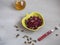 Vegetarian salad of grated boiled beets and seeds in a yellow ceramic salad bowl in the shape of an apple